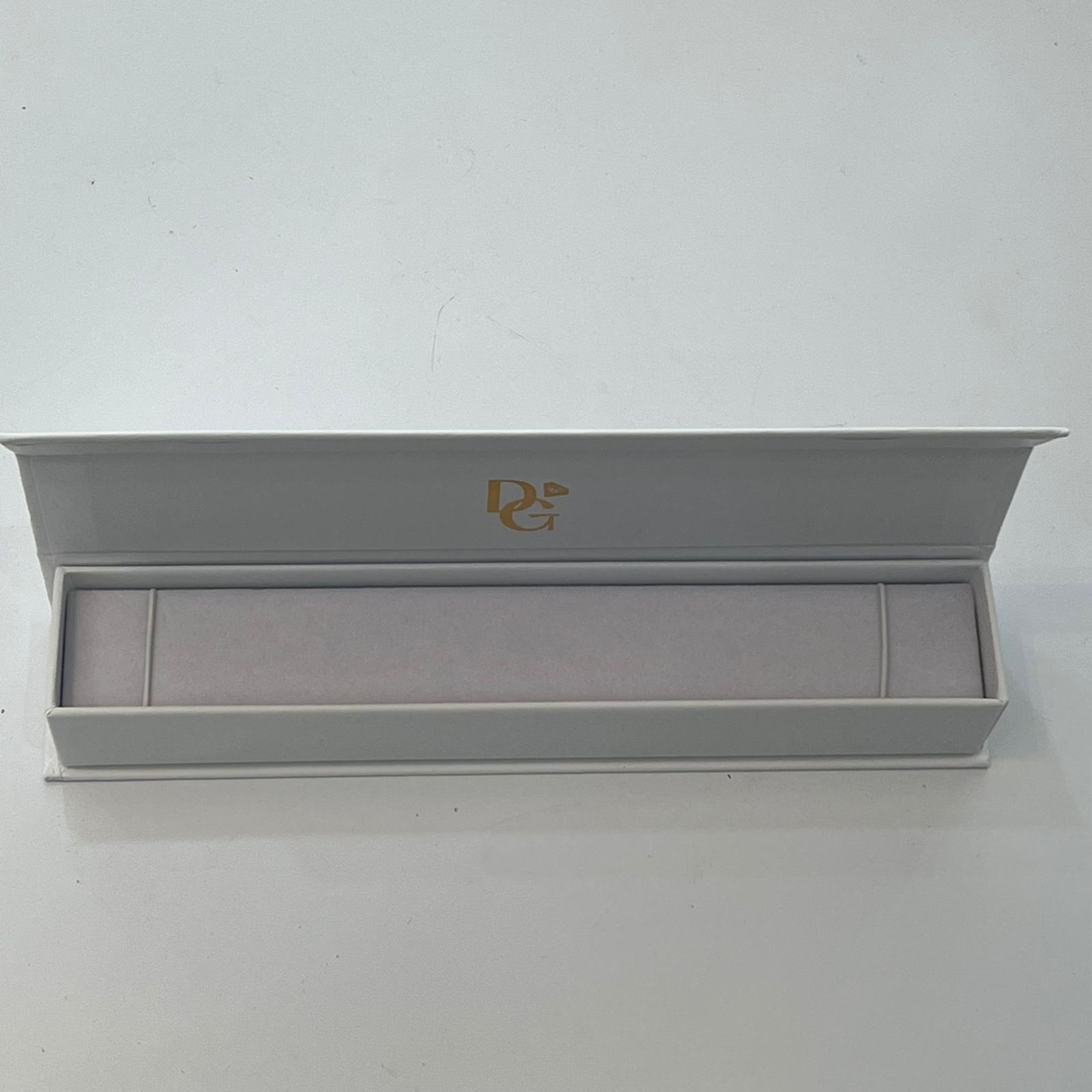 White jewelry box with a gold logo on a white background