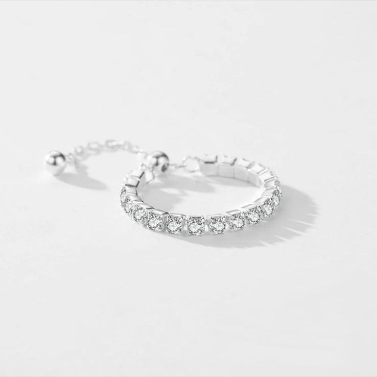 An adjustable 925 sterling silver chain ring with a series of shimmering stones set in a linked chain design.