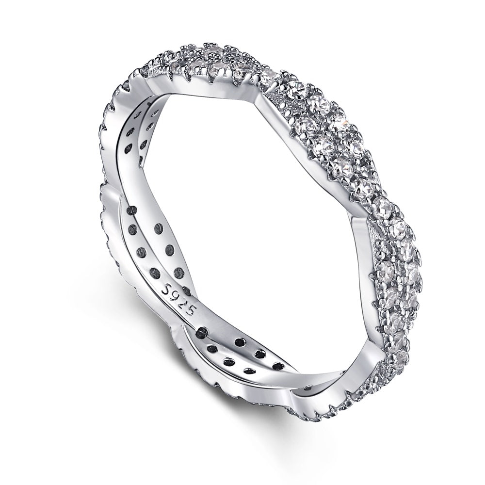 A sterling silver twist ring with multiple pave-set crystals adorning its surface.