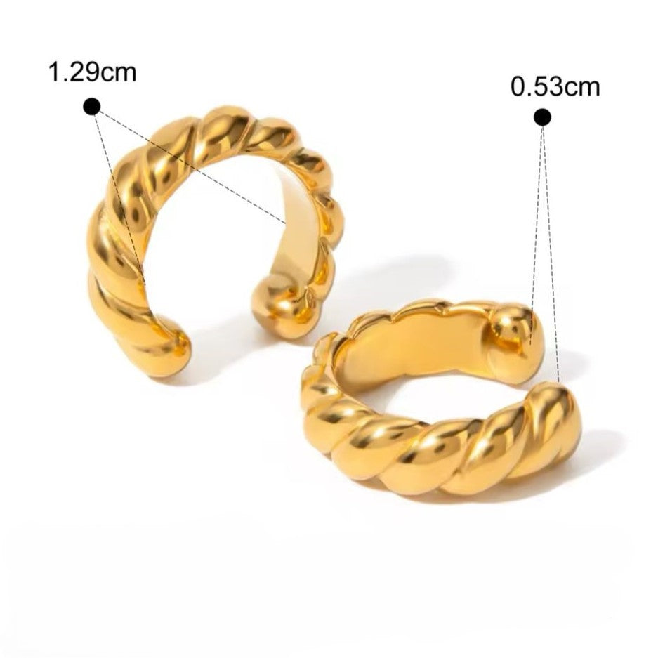 A pair of gold-colored ear cuffs with varying designs displayed on white background.