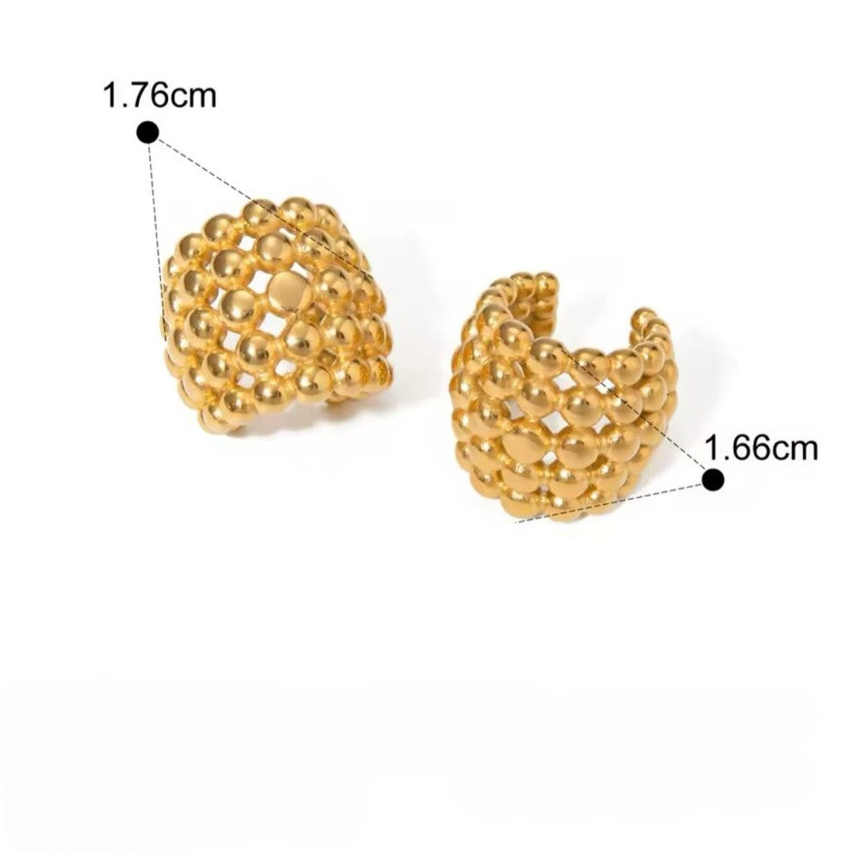 A pair of gold-colored ear cuffs with luxury design displayed on white background.