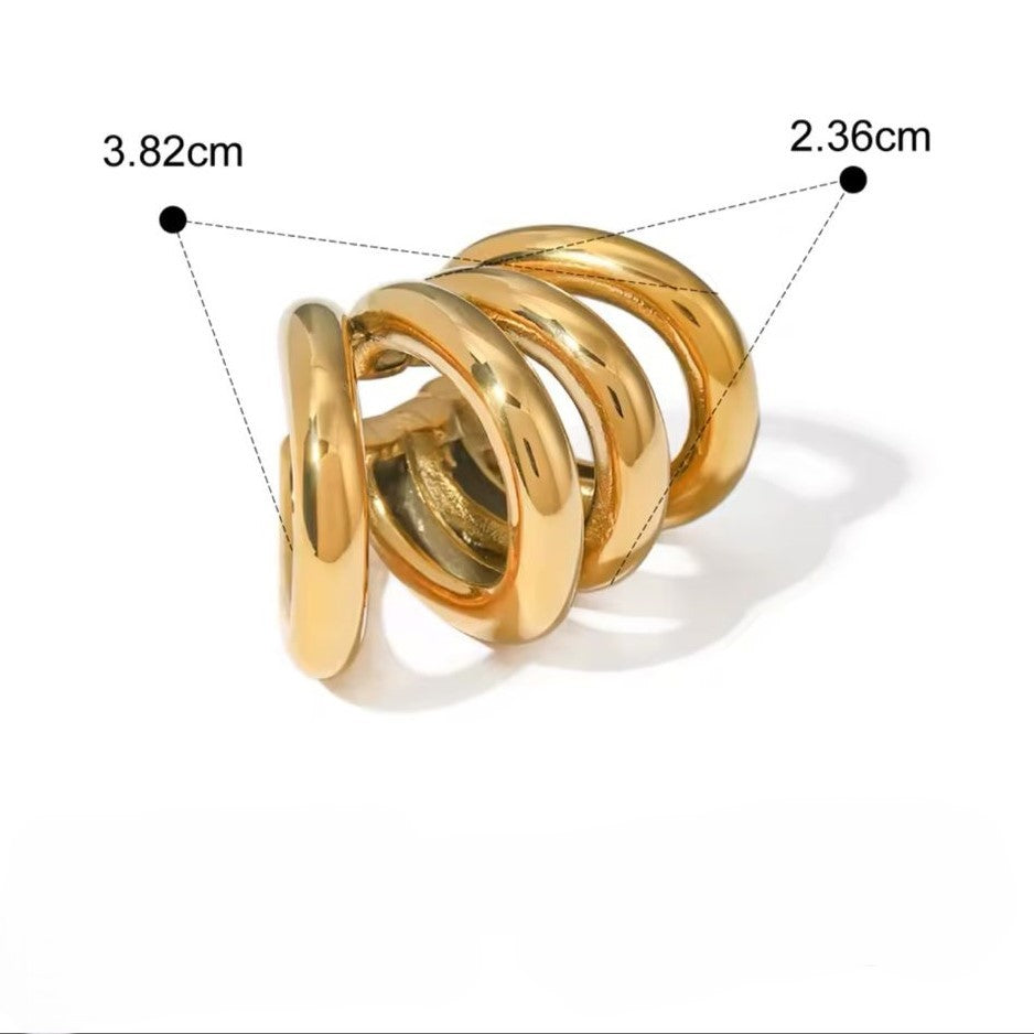 A pair of gold-colored ear cuffs with luxury design displayed on white background.