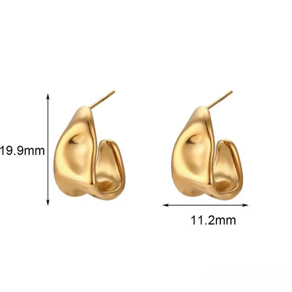 A pair of gold-colored ear cuffs with luxury design displayed on white background.