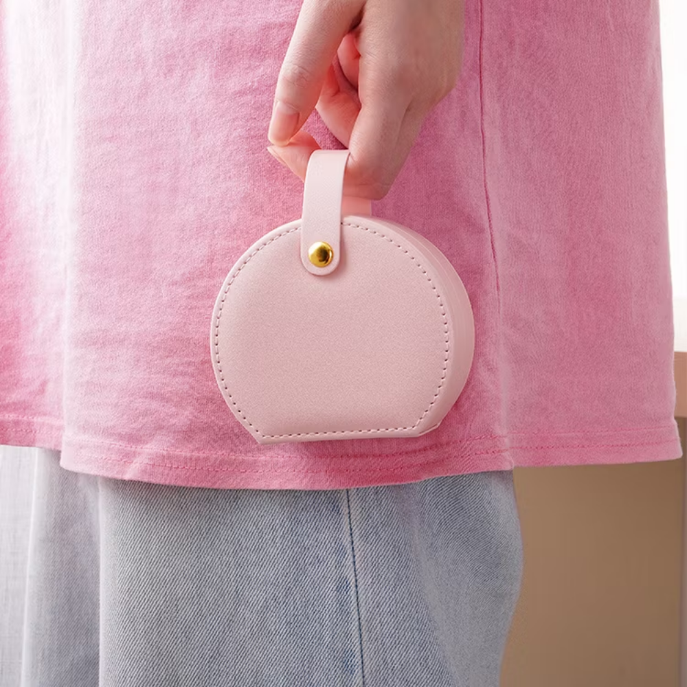 Women holding Mini Round Travel Jewellery Box in Pink