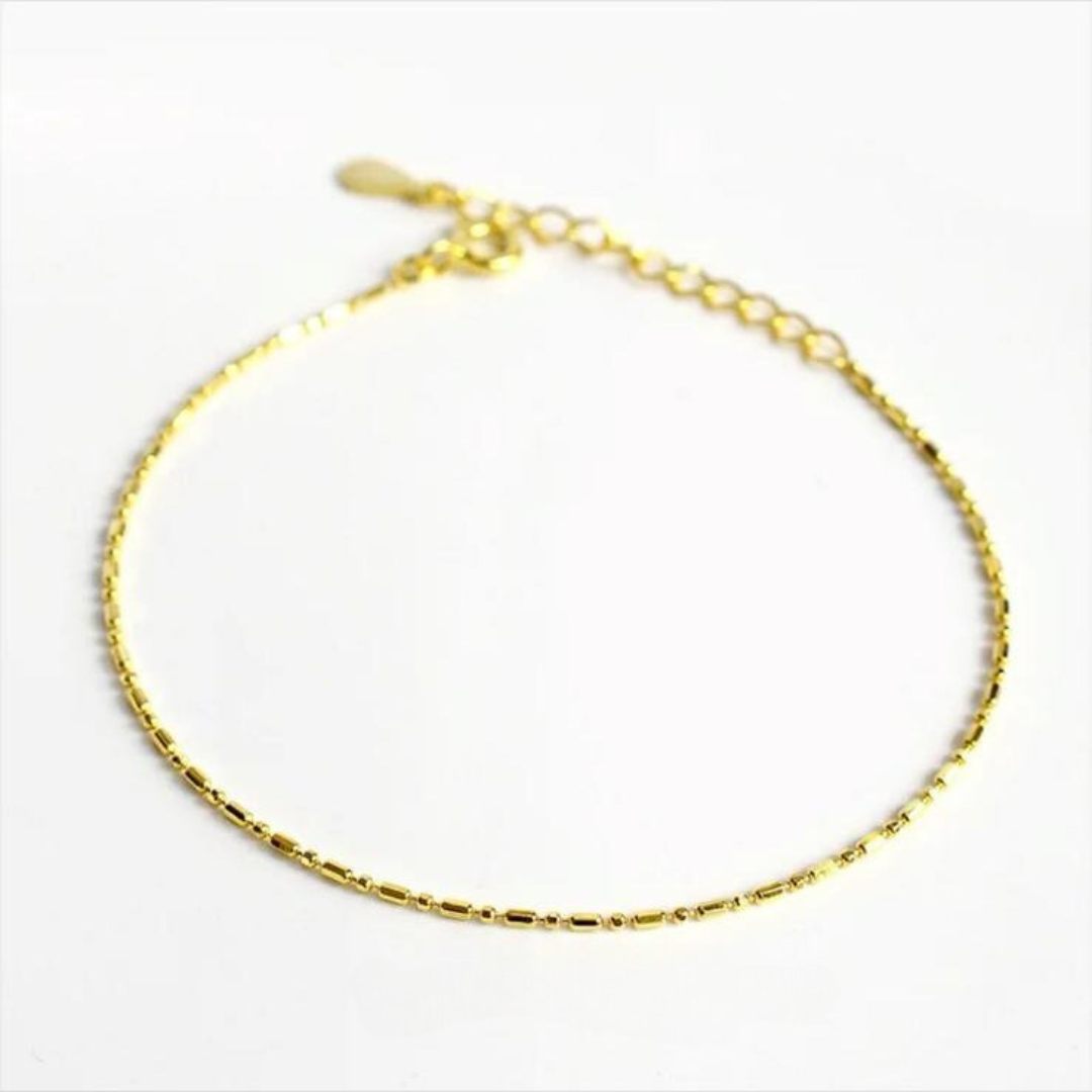 A gold-colored sterling silver chain bracelet with a box clasp closure, presented against a white background.