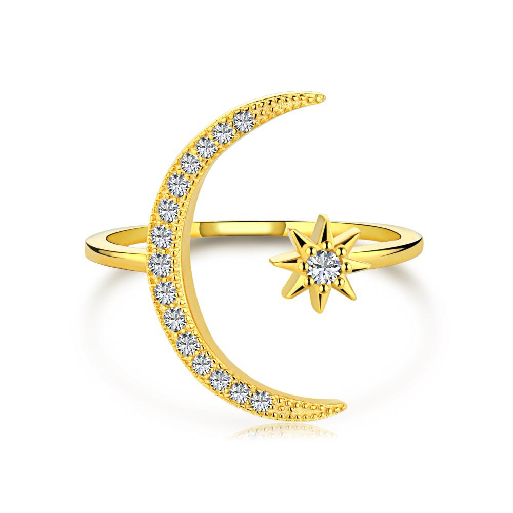 A gold-colored sterling silver ring featuring a crescent moon and a star design with sparkling stones set in the moon and star shapes.