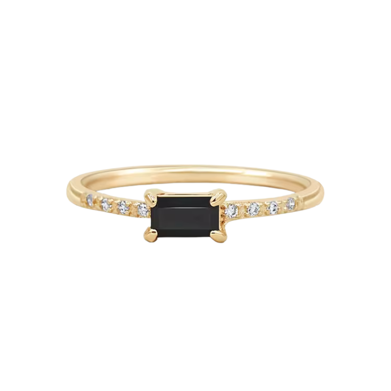 Gold ring with a black gemstone and small diamonds on a white background