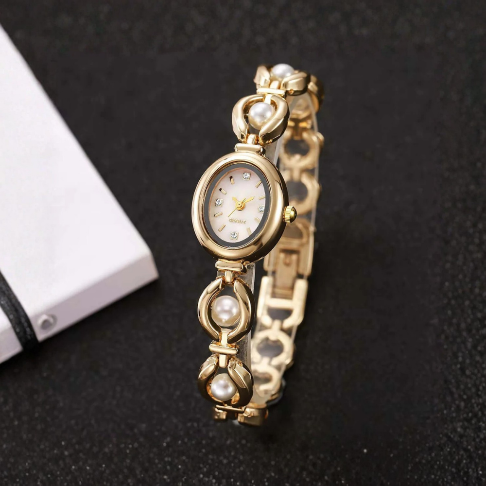 Gold watch with pearl accents on a dark background
