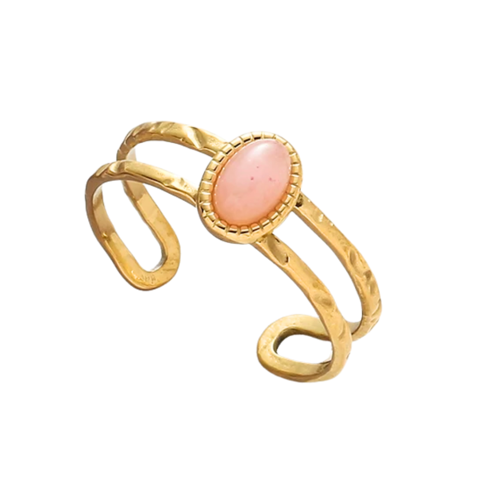 Gold ring with a pink stone on a white background