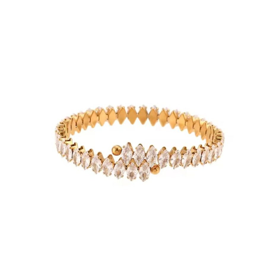 Gold bracelet with clear stones on a white background