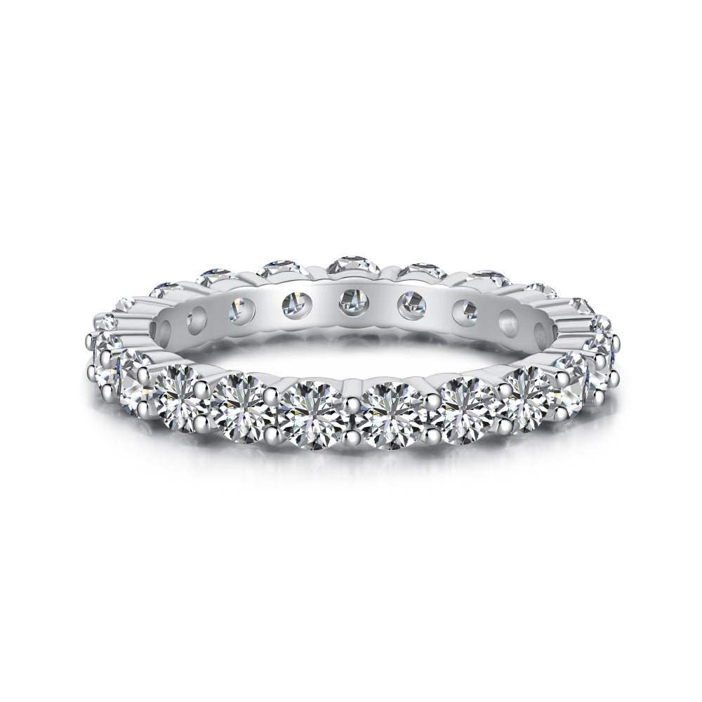 A silver band eternity ring with round-cut cubic zirconia stones set around its entire circumference.