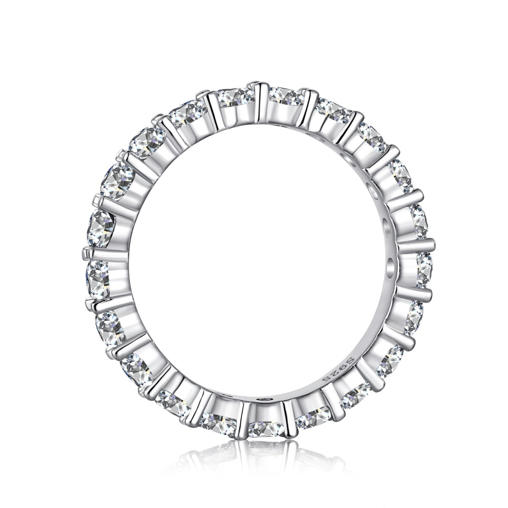 A silver band eternity ring with round-cut cubic zirconia stones set around its entire circumference.