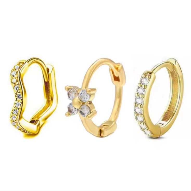Set of 3 Huggie Hoop Earrings in Gold on a white background