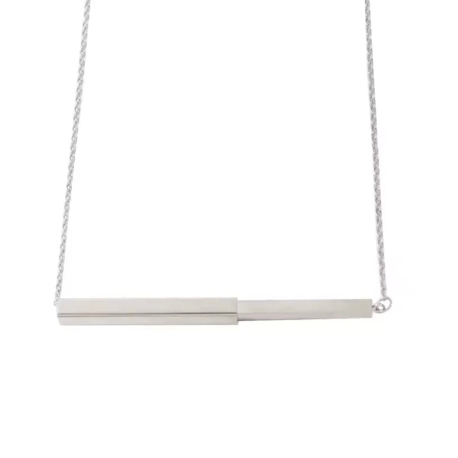 Silver necklace with a bar pendant on a white background
