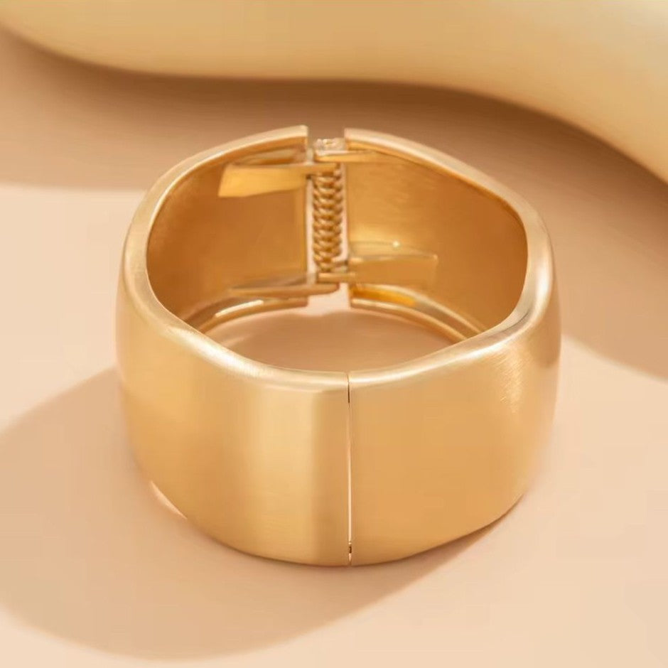 Gold Bangle on a beige background