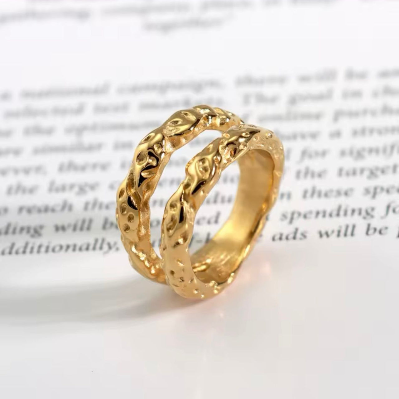 A double band stainless steel ring with 18K gold plating, featuring a textured design.