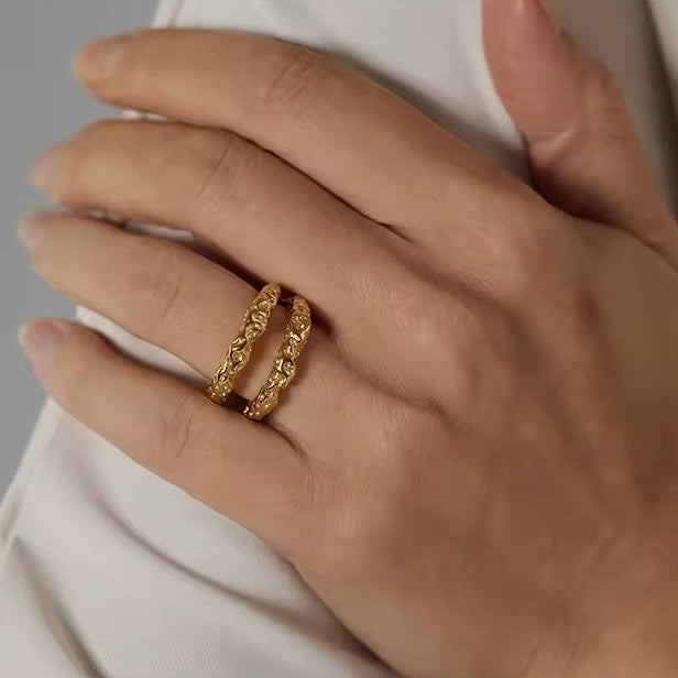 A double band stainless steel ring with 18K gold plating, featuring a textured design.