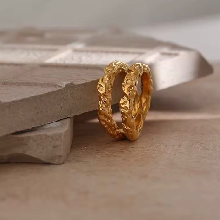 A double band stainless steel ring with 18K gold plating, featuring a textured design.