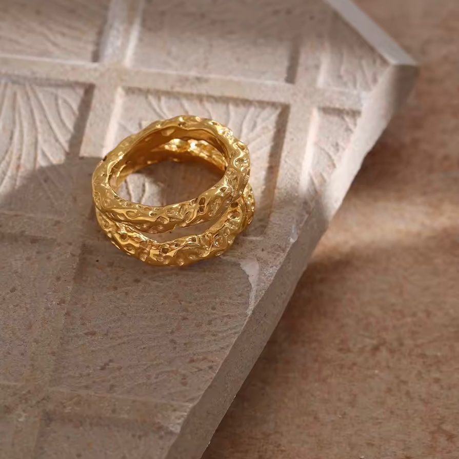 A double band stainless steel ring with 18K gold plating, featuring a textured design.