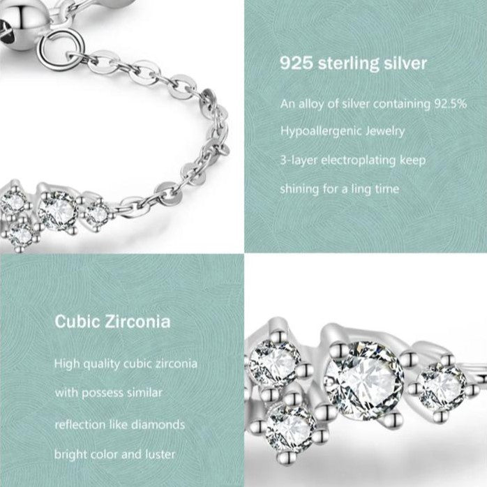 An adjustable sterling silver ring with a chain design and a central spherical embellishment.
