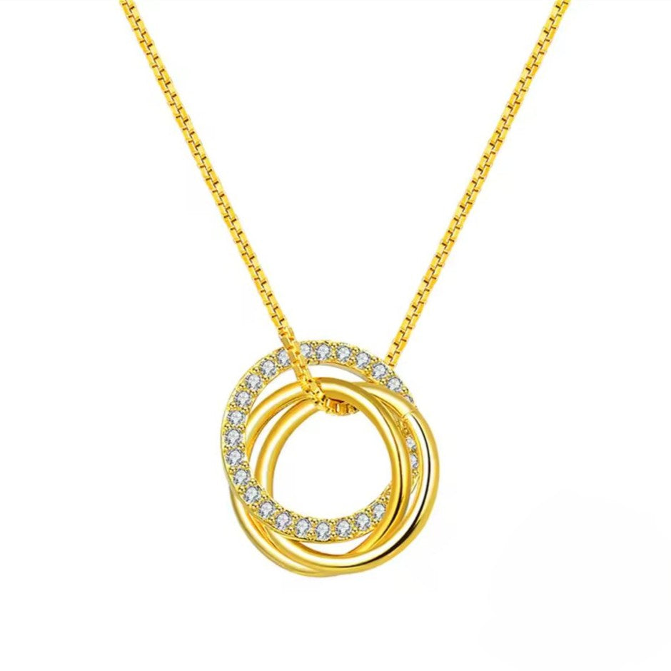Gold necklace with interlocking rings and small diamonds on a white background