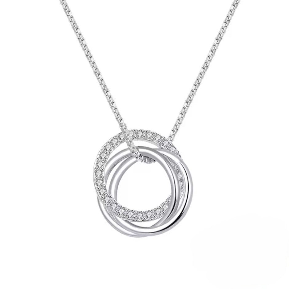 Silver necklace with 3 interlocking rings and small diamonds on a white background