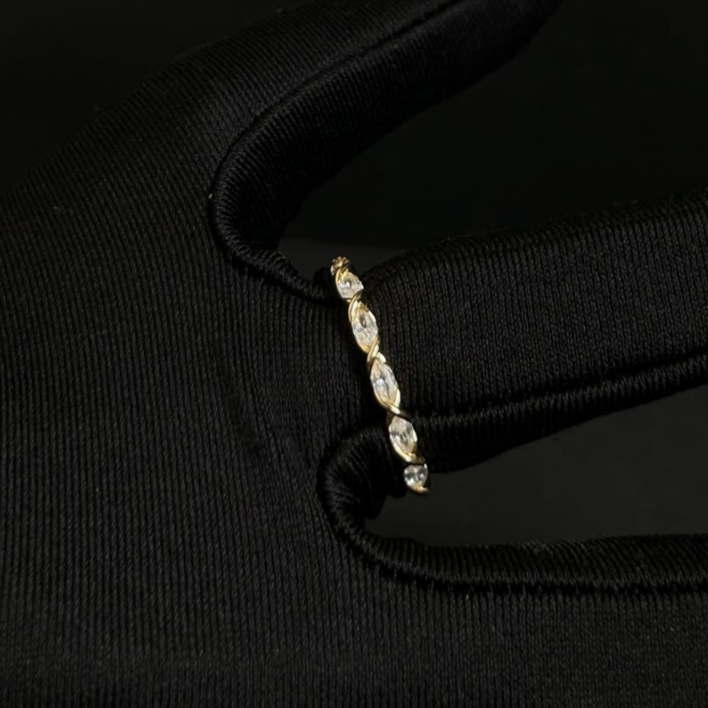Gold ring with small diamonds on a black background