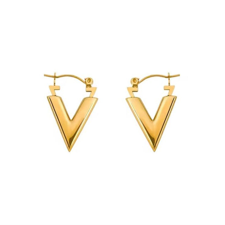 Gold V-shaped hoop earrings on a white background