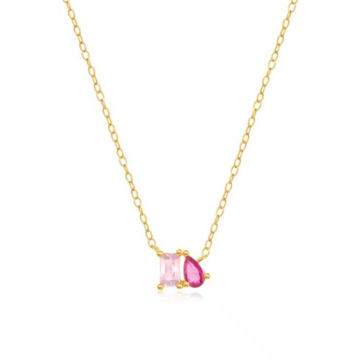 A Gold Velvet spark Necklace with Pink gemstone displayed over a white background.