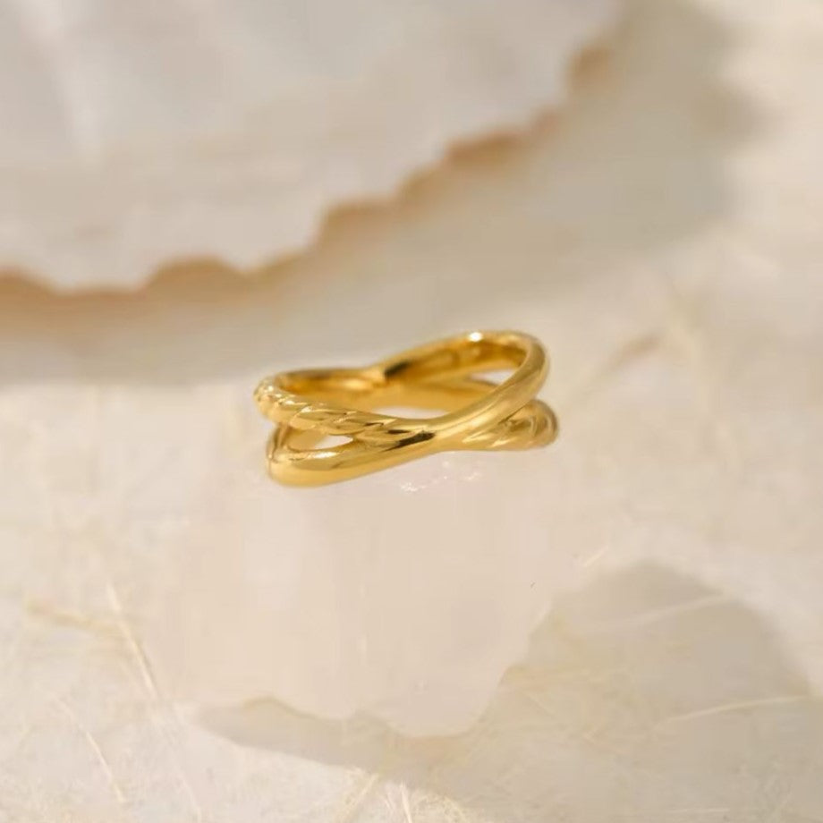 A vintage-inspired twisted stainless steel ring with a gold finish.