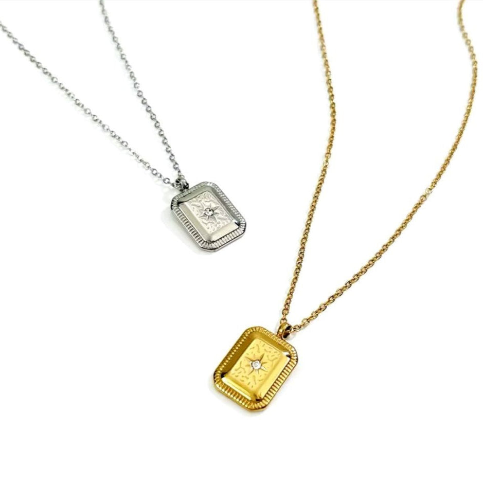 Two vintage geometric charm necklaces with titanium steel square pendants, one plated in gold and the other in silver, displayed against a white background.