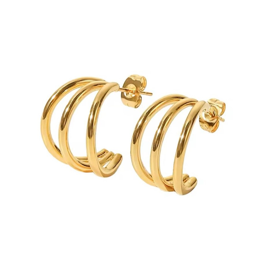 A pair of bold hoop earrings in gold-plated modern style on a white background.