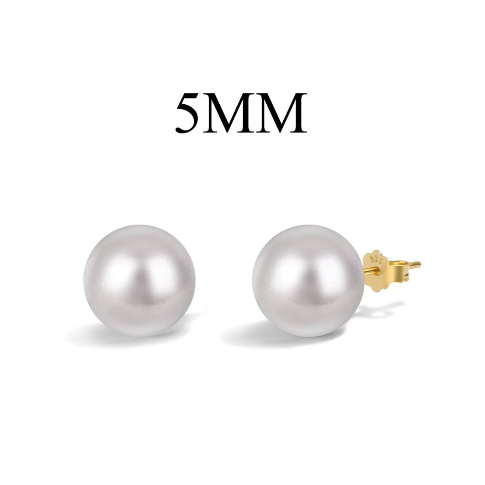 A pair of classic pearl stud earrings with lustrous pearls set against a gold backing on white background.