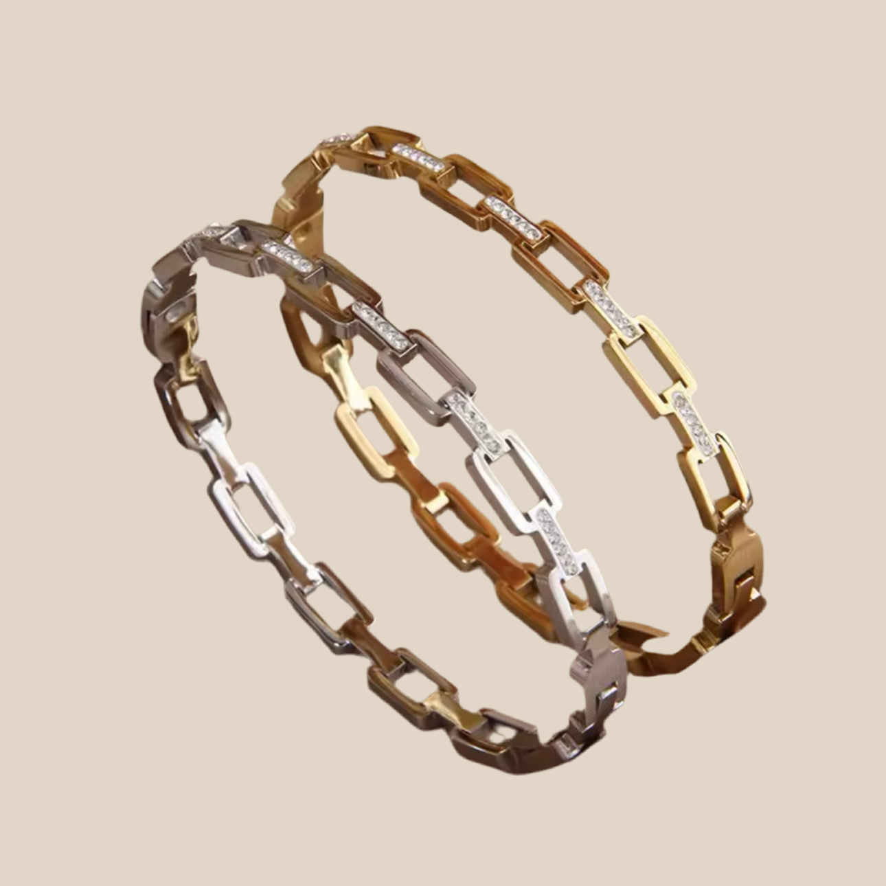 Two gold and silver chain bracelets on a beige background