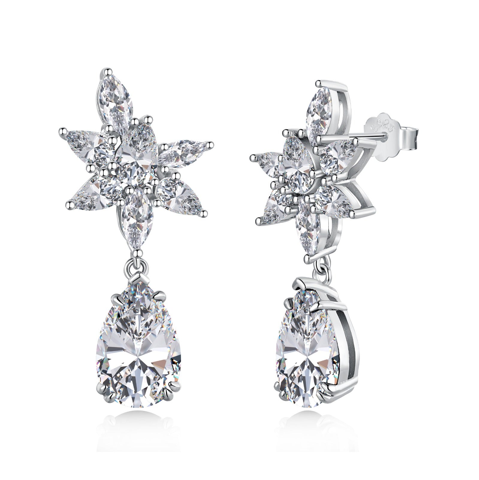 A pair of silver drop earrings featuring pear-shaped clear stones with intricate floral designs above the earrings.