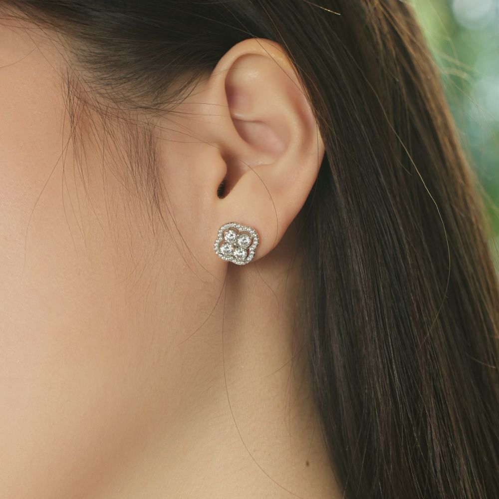 A gold-plated sterling silver clover stud earring with multiple cubic zirconia stones.