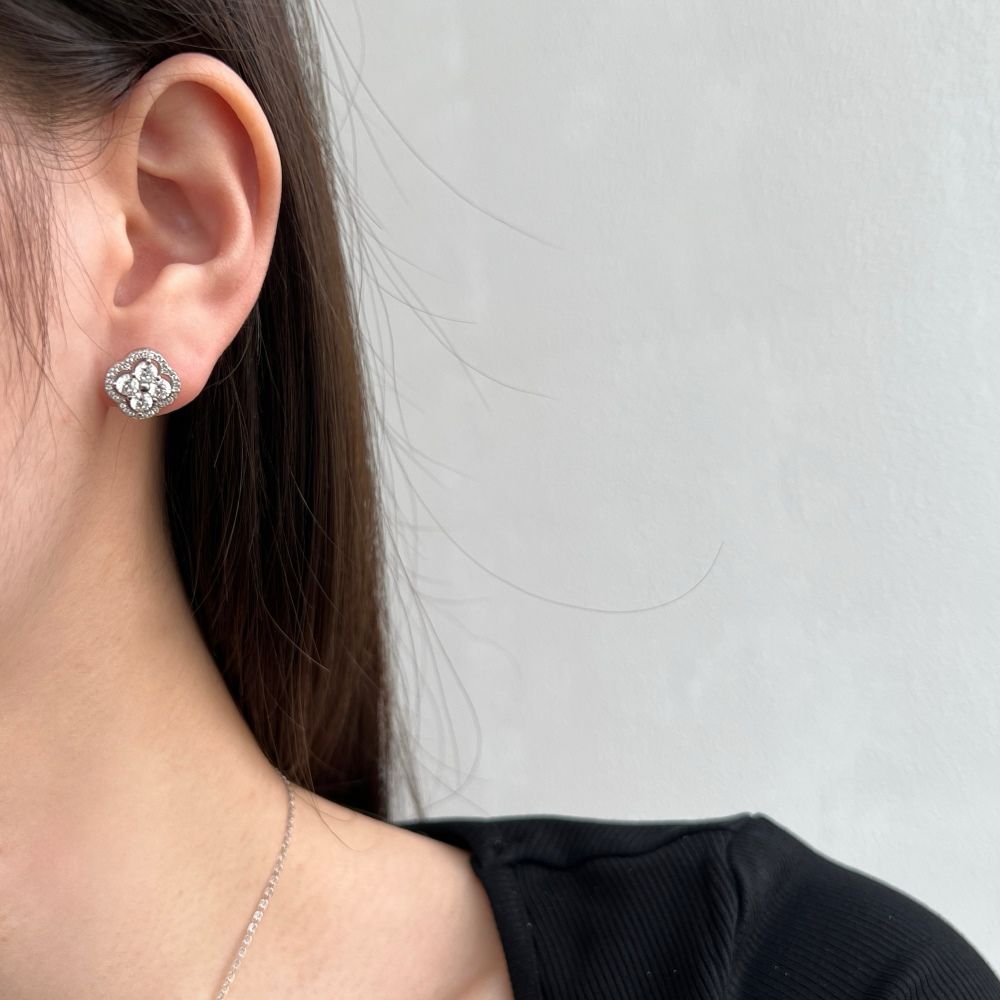 A gold-plated sterling silver clover stud earring with multiple cubic zirconia stones.