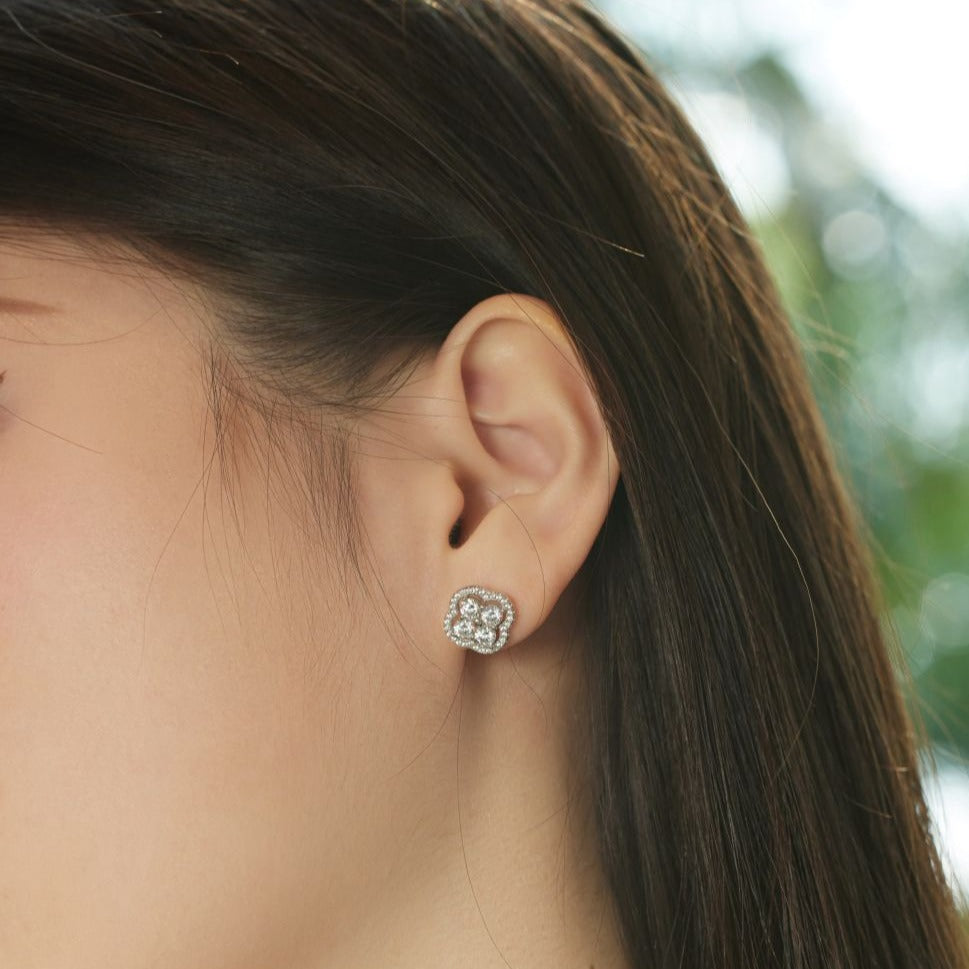 A gold-plated sterling silver clover stud earring with multiple cubic zirconia stones.