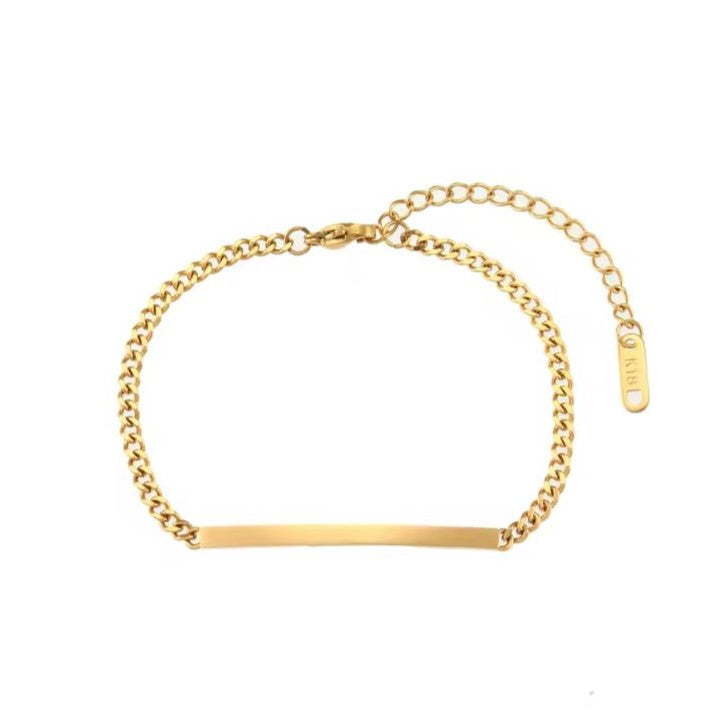 Gold stainless steel bracelet with a curb chain design and an engraved bar pendant in the center.