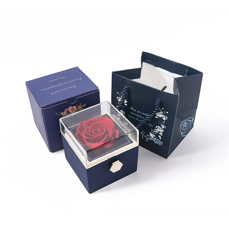 Rotatable gift box with a preserved red rose inside, displayed alongside its packaging boxes.