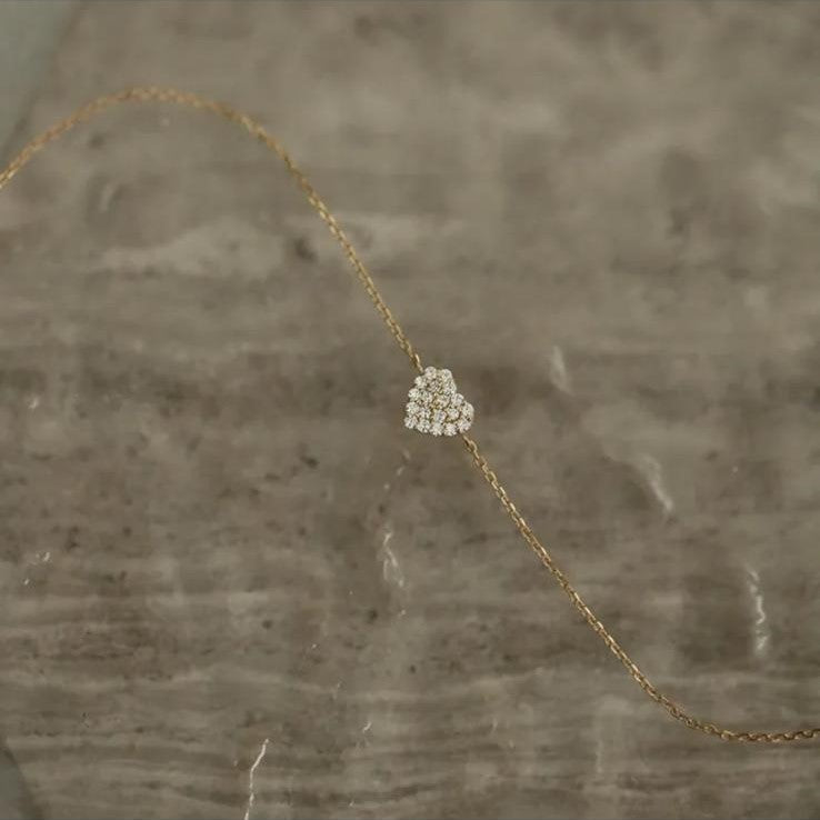 A sterling silver bracelet with a gold plated zirconia heart design.