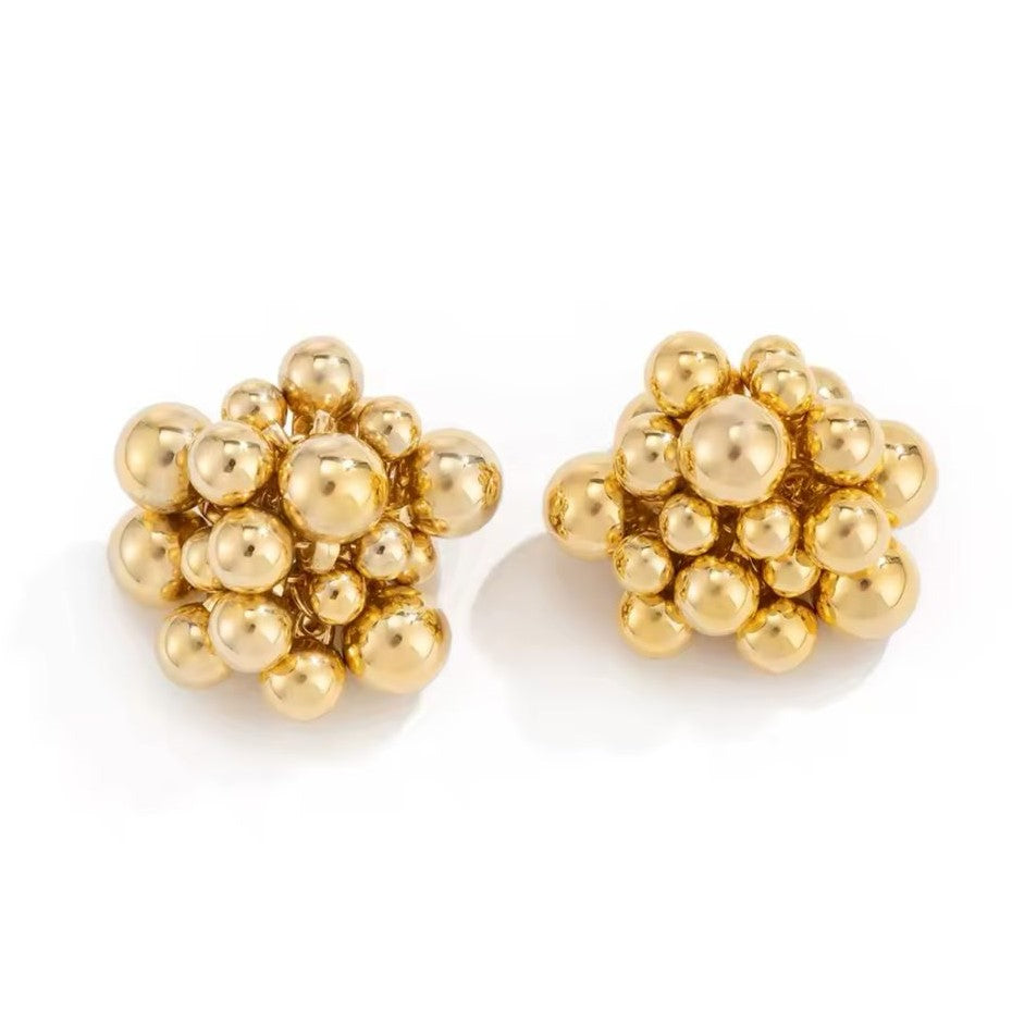 A pair of gold-colored earrings with a honeycomb pattern.
