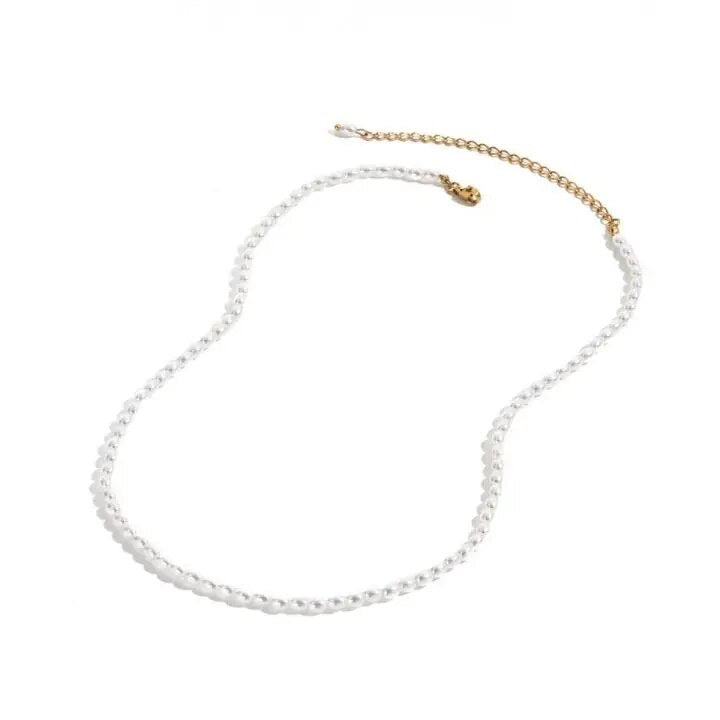 A pearl necklace with a gold-colored chain and multiple small white pearls chain.