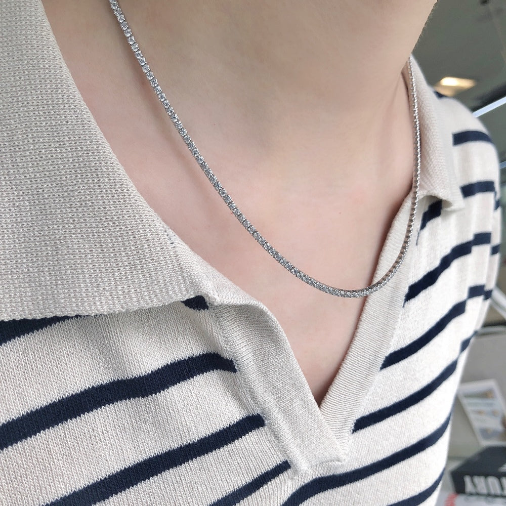 A tennis necklace with round shaped clear zircon stones set in sterling silver.