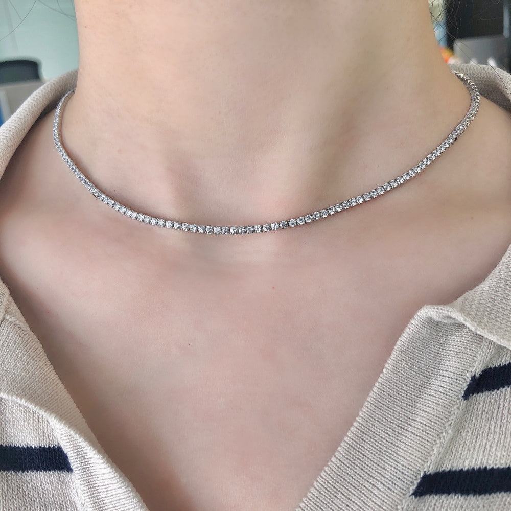 A tennis necklace with round shaped clear zircon stones set in sterling silver.