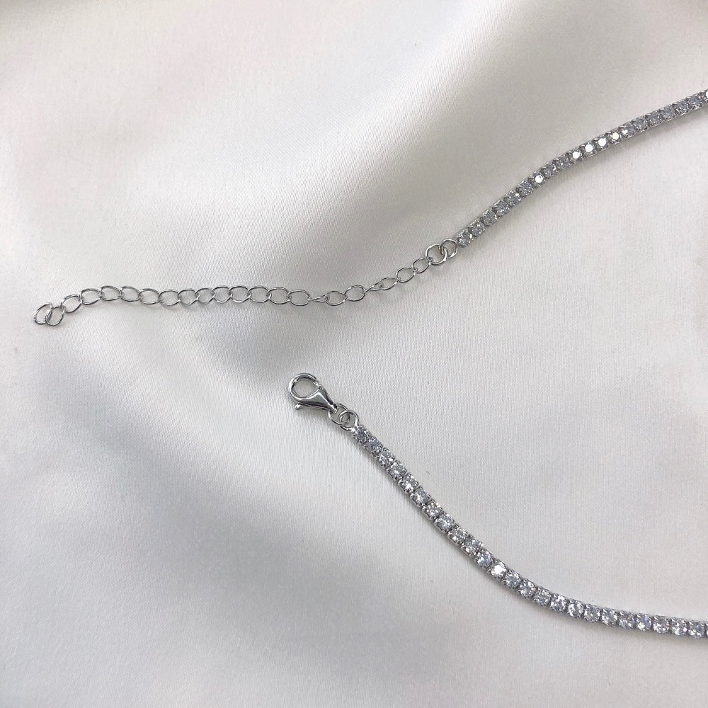 A tennis necklace with round shaped clear zircon stones set in sterling silver.