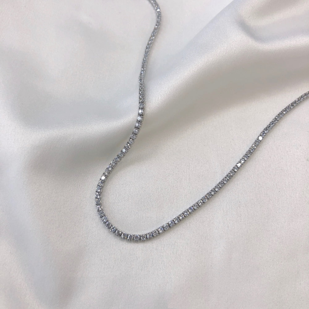 A tennis necklace with round shaped clear zircon stones set in sterling silver.