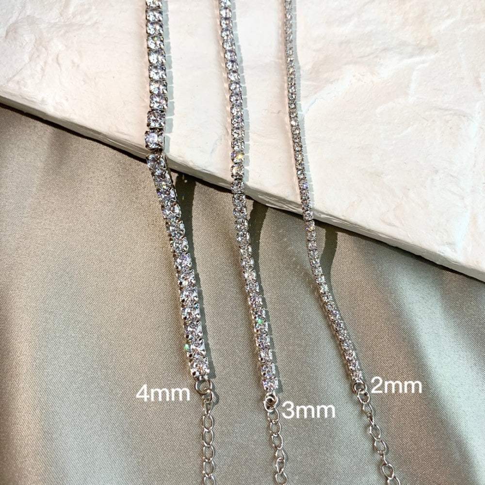 Three tennis necklaces with round shaped clear zircon stones set in sterling silver with different sizes.