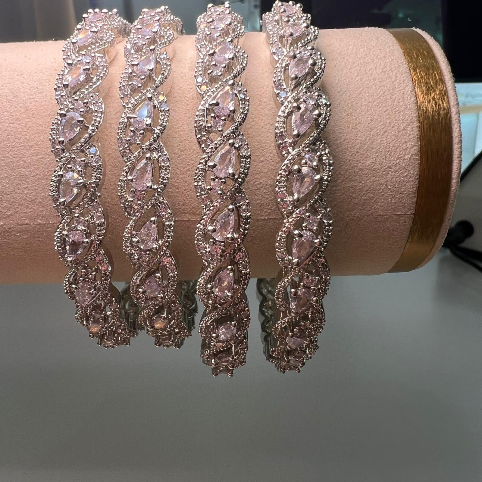 Set of Four pink diamond-encrusted bracelets on a pink cushion