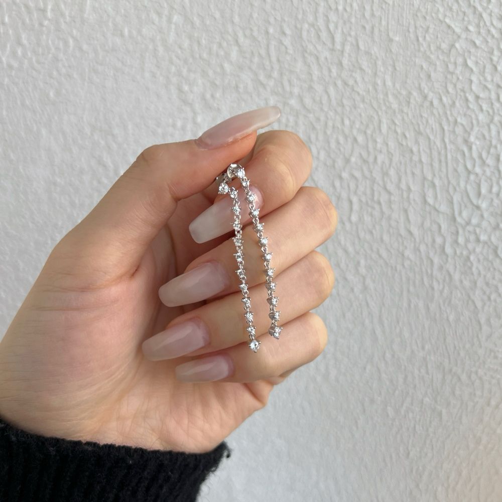 A collection of long drop earrings featuring a series of clear cubic zirconia stones set in sterling silver.